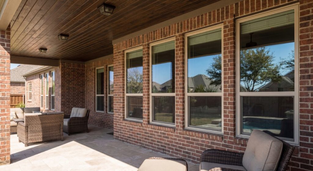 Almond Low-E windows installed on a covered patio porch of a Texas brick home - Optimal Windows
